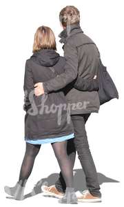 couple in black coats walking arm in arm