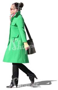 woman with a green coat walking