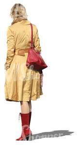 cut out woman in a yellow coat standing