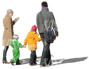 family of four walking hand in hand