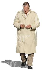 cut out man in a beige trenchcoat walking