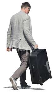 man in a suit carrying a suitcase 