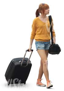 woman in shorts pulling a suitcase