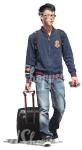 young asian man pulling a suitcase