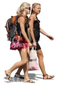 two young women with backpacks walking in summer