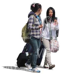 two asian women walking with suitcases