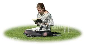 woman sitting on the grass and reading a book