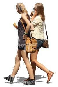 two teenage girls walking and eating an ice cream