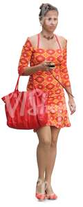woman in an orange summer dress walking