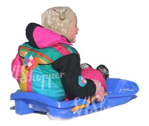 little girl sitting on a sledge