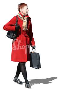 cut out woman in a red autumn coat walking