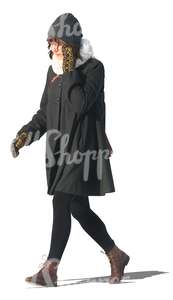 cut out woman in a black winter coat walking