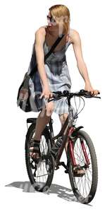 woman in a dress riding a bike