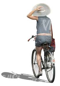 woman with a large hat riding a bike