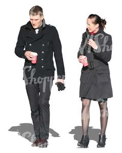 man and woman walking and drinking coffee