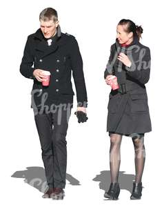 man and woman walking and drinking coffee