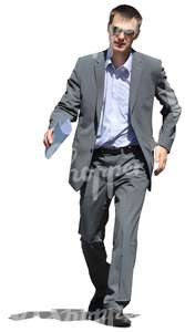 businessman with notes in his hands walking hastily