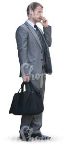 businessman with a bag standing an talking on the phone
