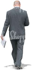 businessman walking with a notebokk in his hand