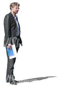 businessman standing with a notebook in his hand