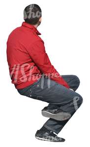 man in a red jacket sitting