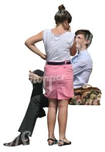 woman standing and talking to a sitting man