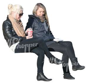 two women sitting and drinking coffee