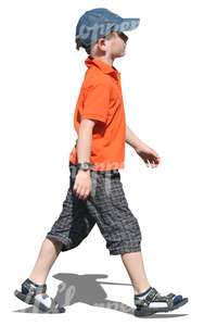 young boy with a baseball cap walking