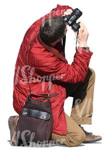 cut out man kneeling and taking a picture