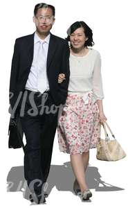 asian couple in formal clothes walking arm in arm