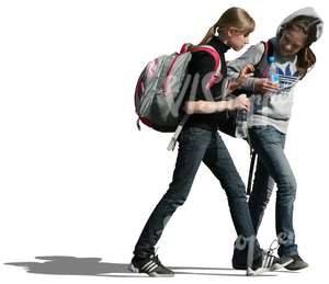 two teenage girls with backpacks walking together