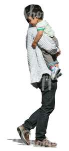 asian man walking and carrying his son 