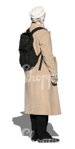 woman in a beige autumn coat standing