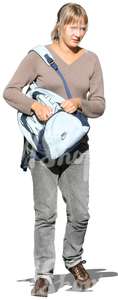 woman walking and looking in her backpack