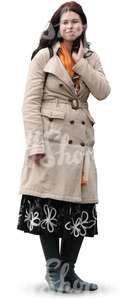 woman in a beige autumn coat standing