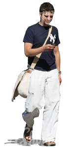 man walking and looking at his phone