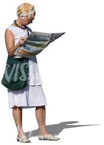 woman standing and reading a newspaper