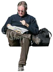 man sitting and reading a newspaper