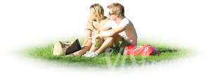 two people sitting together on the grass