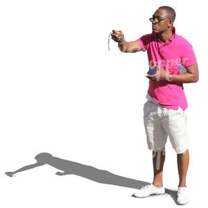 black man in shorts taking a picture