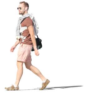 man in shorts walking happily