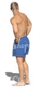 man in swim shoerts standing