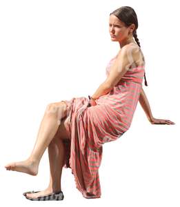 woman in a long dress sitting barefoot