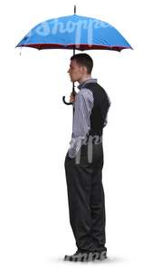 man in a suit standing uder an umbrella