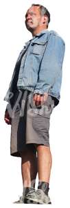 man in a denim jacket standing seen from below