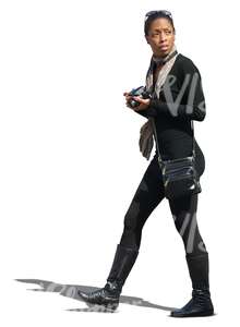 black woman walking and holding a camera