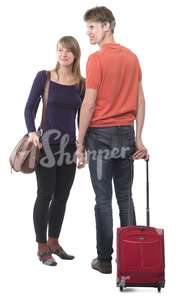 travelling couple standing with a suitcase