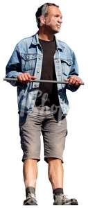 man in a denim jacket standing against the railing