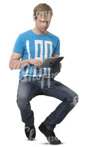 young man sitting and looking at his iPad