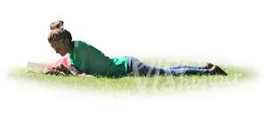 woman lying on the grass and reading a book